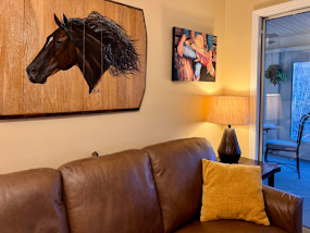 A beautiful horse overlooks the living room at this Pointe Royale Branson condo.